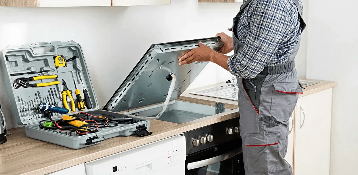 Handyman repairing a cooktop and checking wiring connections in Hollywood, FL