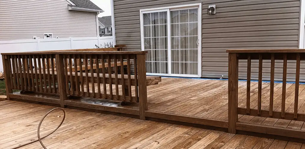 Deck sealing service protecting a backyard wood deck and railings in Hollywood, FL