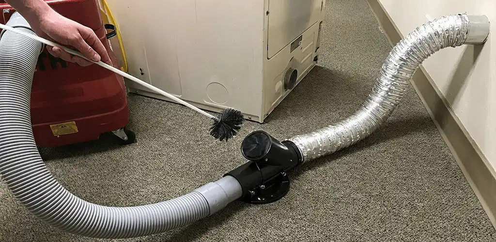 Dryer vent cleaning service removing lint from a dryer duct connection in Hollywood, FL