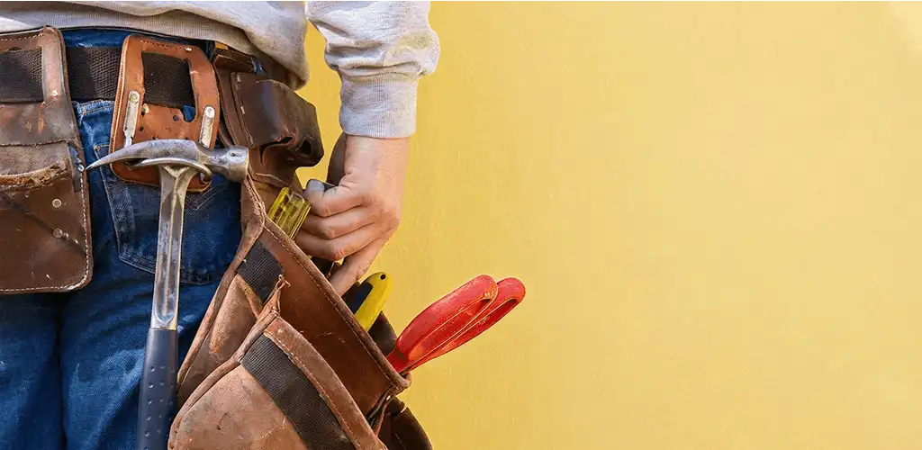 Handyman with tool belt ready for home repairs and maintenance in Hollywood, FL