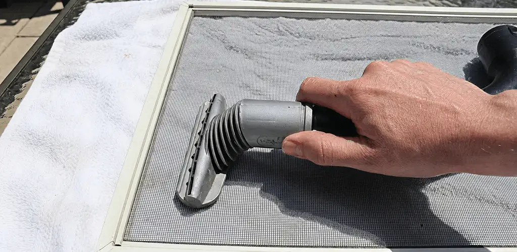 Window screen repair cleaning and fixing a damaged screen mesh in Hollywood, FL